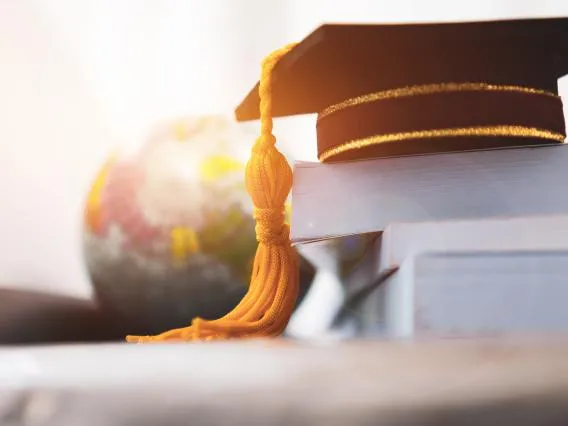 Graduation cap in front of globe